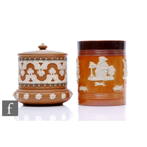 504 - Two Doulton stoneware tobacco jars and covers, each decorated with relief moulded figural and floral... 