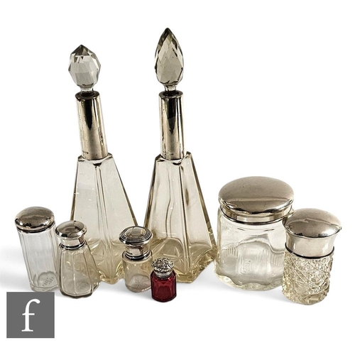 272 - A collection of Victorian and later glass silver topped scent and dressing table jars, all of varyin... 