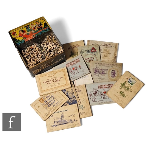 237 - A wooden fret cut jigsaw puzzle in a 1920s  Lyons Jazz assortment biscuit tin with good lithograph t... 