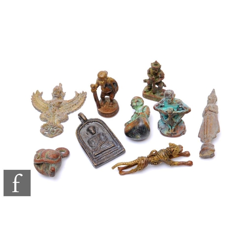 262 - A collection of 20th Century South East Asian bronze charms, to include a running tiger, sage with a... 