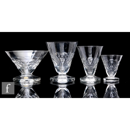 780 - A 20th Century part matched suite of drinking glasses, each of conical form bowls with basal facet c... 