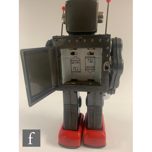 34 - A 1960s Japanese Horikawa Machine Robot, battery operated tinplate toy in grey with red feet, clear ... 