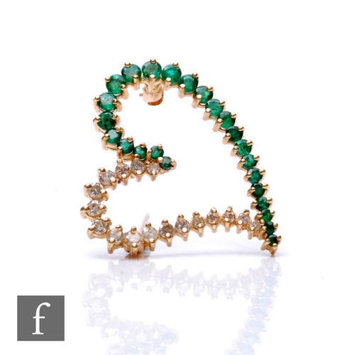 113 - A 14ct emerald and diamond open heart shaped brooch  comprising graduated claw set stones, weight 4.... 