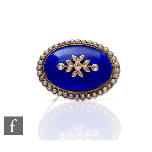 115 - An early 20th Century 9ct oval brooch with central diamond spray to a blue enamelled ground, all wit... 