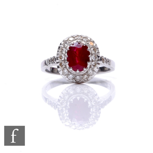 118 - An 18ct hallmarked white gold ruby and diamond cluster ring, central oval ruby, length 8mm, claw set... 