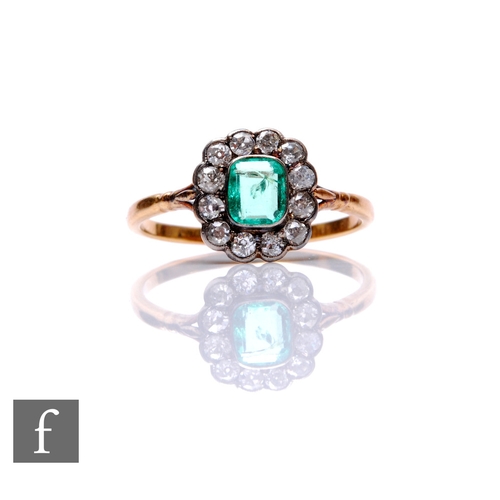 130 - A 9ct emerald and diamond cluster ring, emerald cut central emerald to a border of twelve transition... 