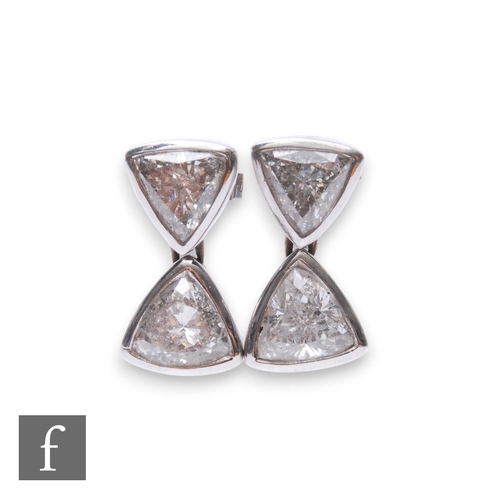 176 - A pair of 18ct white gold diamond drop earrings each comprising two brilliant cut diamonds in a rub ... 