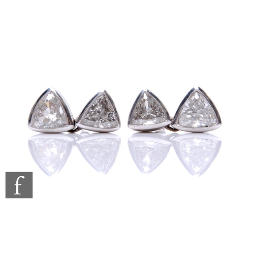 176 - A pair of 18ct white gold diamond drop earrings each comprising two brilliant cut diamonds in a rub ... 