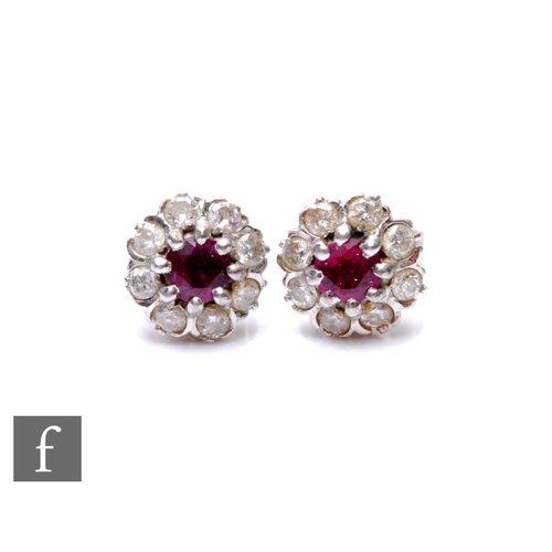 179 - AMENDED DESCRIPTION A pair of 18ct white gold ruby and diamond circular cluster stud earrings, centr... 