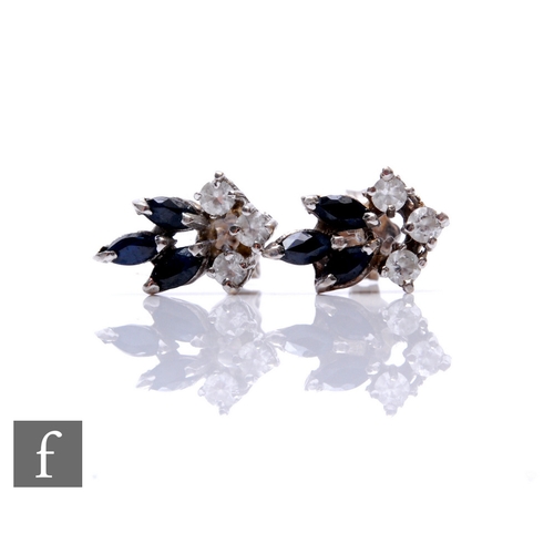 181 - A pair of 18ct white gold sapphire and diamond stud earrings, three marquise sapphire and three diam... 