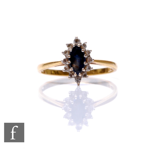 185 - An 18ct hallmarked sapphire and diamond marquise shaped cluster ring, central sapphire within a twel... 