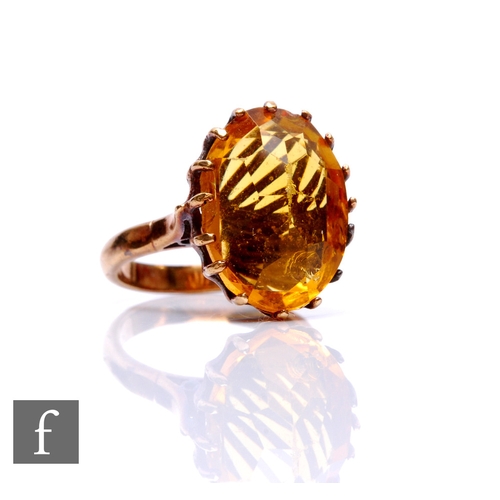 61 - A 9ct single stone citrine ring, claw set oval stone to plain shoulders, weight 6g, ring size M.