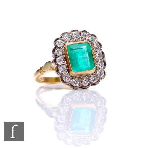 64 - An 18ct hallmarked emerald and diamond cluster ring, emerald cut emerald, length 9mm, collar set wit... 