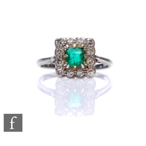 66 - An 18ct emerald and diamond cluster ring, central square cut emerald within a border of twelve diamo... 