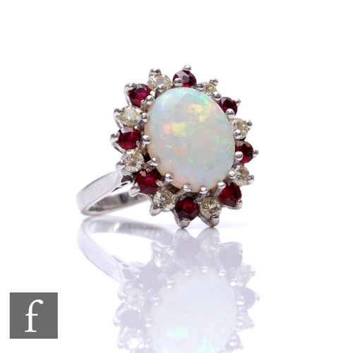 67 - An 18ct hallmarked white gold, opal, diamond and ruby cluster ring, central oval opal, length 12mm, ... 