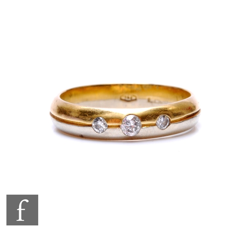 71 - An 18ct white and yellow gold diamond three stone ring, three sunk set stones to a bi-colour shank, ... 