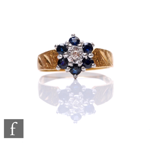 72 - An 18ct sapphire and diamond cluster ring, central diamond within a six stone sapphire border, weigh... 