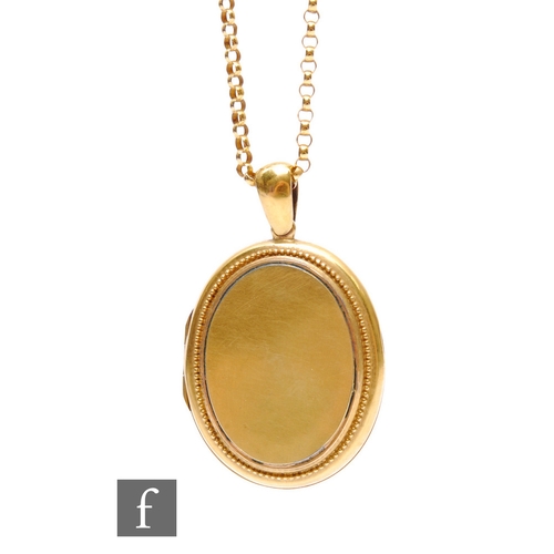 82 - A 15ct oval locket, length 4.5cm, weight 12g, suspended from a 9ct belcher chain, weight 3.7g, lengt... 