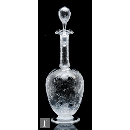 734 - An Art Nouveau glass decanter of footed ovoid form with tall collar neck, polished intaglio cut with... 