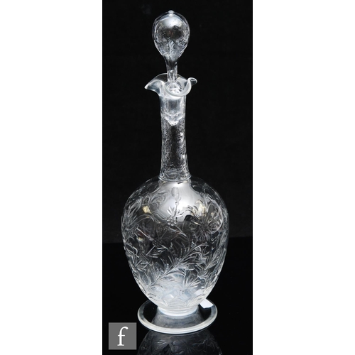 734 - An Art Nouveau glass decanter of footed ovoid form with tall collar neck, polished intaglio cut with... 