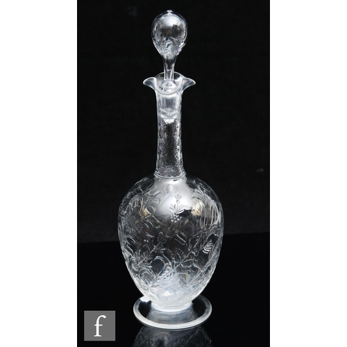 734 - An Art Nouveau glass decanter of footed ovoid form with tall collar neck, polished intaglio cut with... 