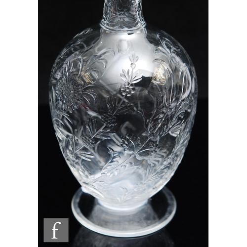 734 - An Art Nouveau glass decanter of footed ovoid form with tall collar neck, polished intaglio cut with... 