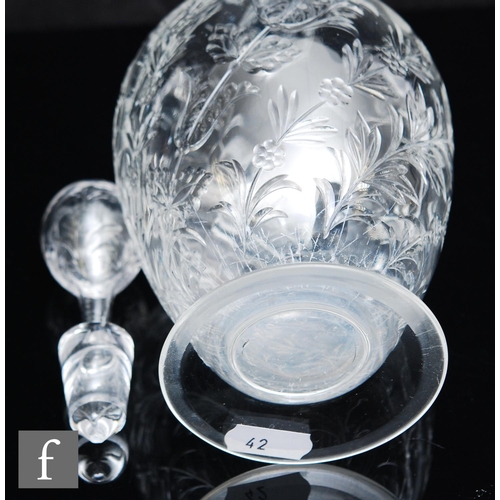 734 - An Art Nouveau glass decanter of footed ovoid form with tall collar neck, polished intaglio cut with... 