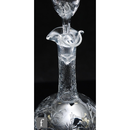 734 - An Art Nouveau glass decanter of footed ovoid form with tall collar neck, polished intaglio cut with... 