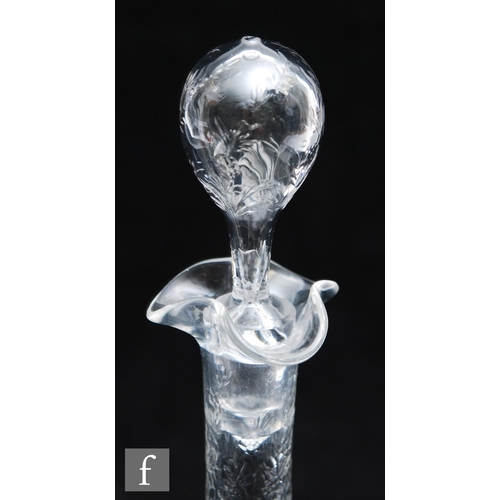 734 - An Art Nouveau glass decanter of footed ovoid form with tall collar neck, polished intaglio cut with... 