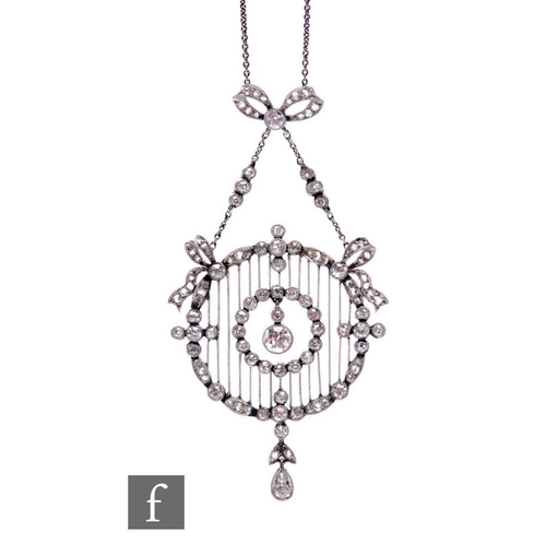 193A - An Edwardian white gold bellle epoque circular diamond open work pendant with central old cut diamon... 