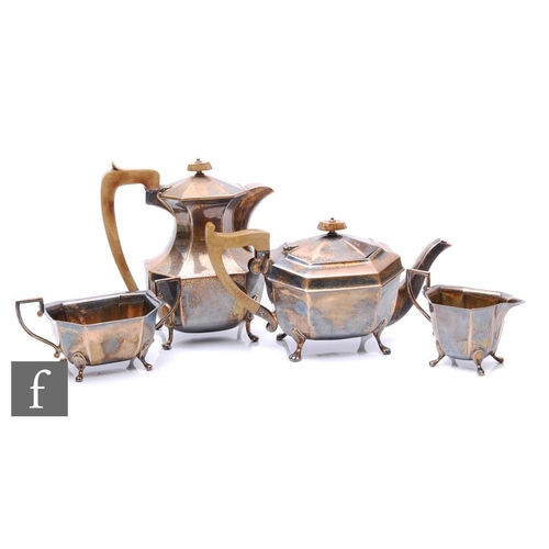 30A - A hallmarked silver four piece tea set of octagonal plain form each raised on four paw feet, total w... 