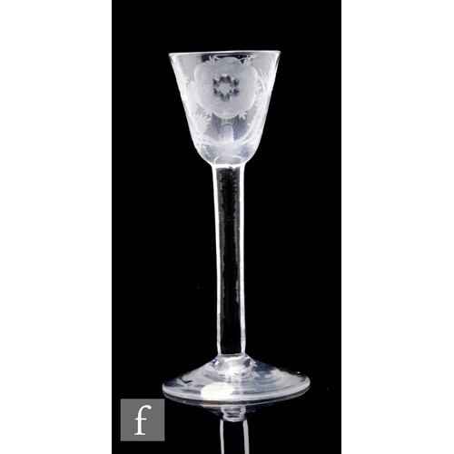 109 - An 18th Century Jacobite drinking glass circa 1740, the round funnel bowl engraved with rose on leaf... 