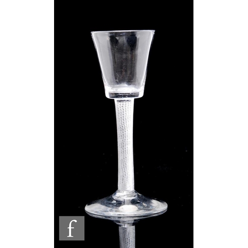 115 - An 18th Century drinking glass circa 1750, the bucket form bowl above an air twist stem, raised to a... 