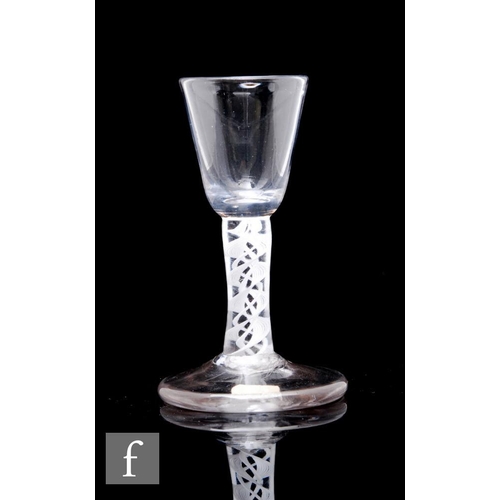 116 - An 18th Century miniature drinking glass or dram, the small round funnel bowl above a double series ... 