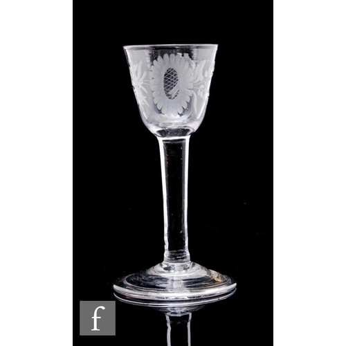 120 - An 18th Century drinking glass circa 1740, the round funnel bowl engraved with a stylised flower wit... 