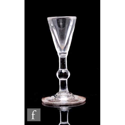 123 - An 18th Century dram or miniature drinking glass, the deceptive conical bowl above a solid plain ste... 