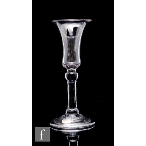 63 - An 18th Century gin glass circa 1730, the dark metal glass with slender bell bowl above a balustroid... 