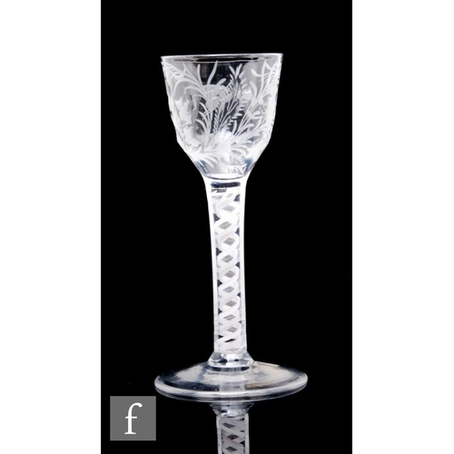 78 - An 18th Century drinking glass circa 1765, the ogee bowl engraved with lily of the valley and a moth... 