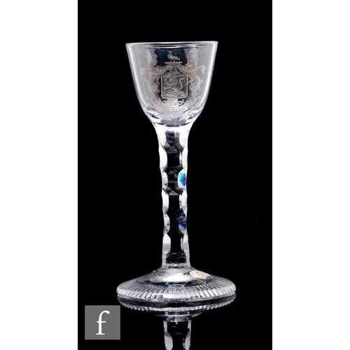 82 - An 18th Century drinking glass circa 1775, the round funnel bowl engraved with an armorial crest abo... 