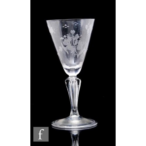 88 - An 18th Century continental drinking glass, the large pointed round funnel bowl engraved with stylis... 