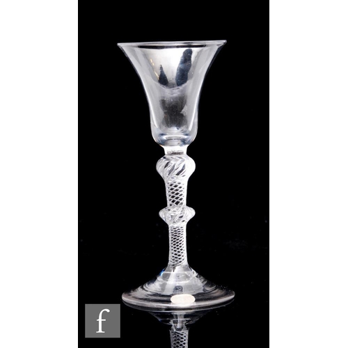 96 - An 18th Century drinking glass circa 1750, the bell form bowl above an air twist stem with large upp... 