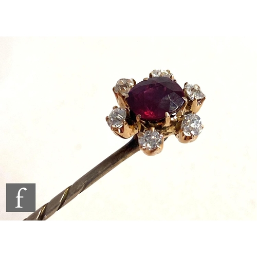 93 - An early 20th Century ruby and diamond set stick pin, central ruby, length 10mm, within a border of ... 