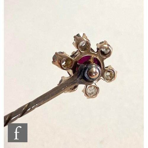 93 - An early 20th Century ruby and diamond set stick pin, central ruby, length 10mm, within a border of ... 