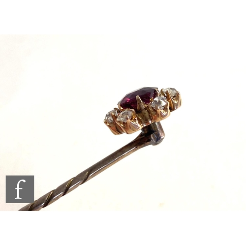 93 - An early 20th Century ruby and diamond set stick pin, central ruby, length 10mm, within a border of ... 