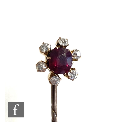 93 - An early 20th Century ruby and diamond set stick pin, central ruby, length 10mm, within a border of ... 