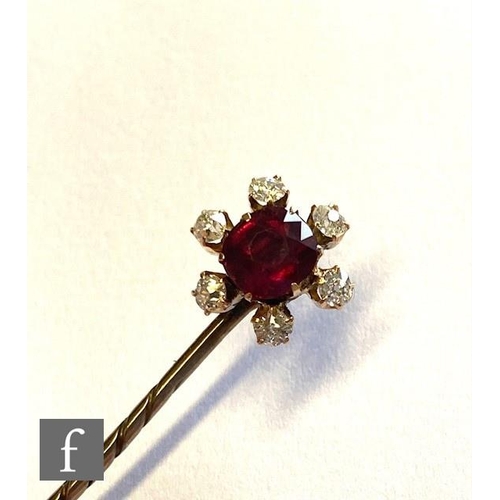 93 - An early 20th Century ruby and diamond set stick pin, central ruby, length 10mm, within a border of ... 