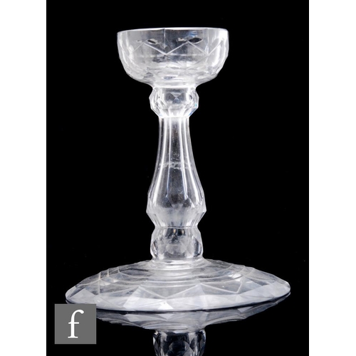 158 - A late Georgian clear crystal glass ham stand, the wide circular base rising to a slice and facet cu... 