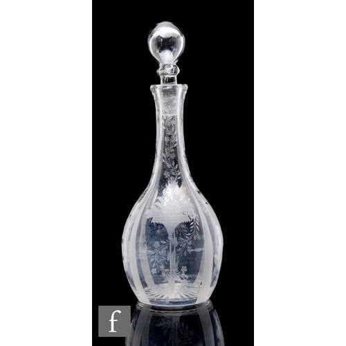 765 - A Victorian clear crystal glass decanter the slender bottle form engraved with panels of flowers and... 