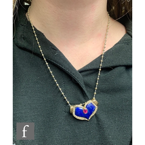 114 - A 14ct ruby, lapis lazuli and diamond set cushioned heart shaped pendant suspended from a 14ct yello... 