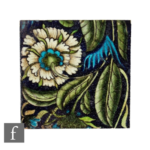 A 19th Century William De Morgan 6 inch plastic clay tile decorated with trailing chrysanthemum, with green swirling leaves and turquoise highlights, impressed Sands End Pottery mark.